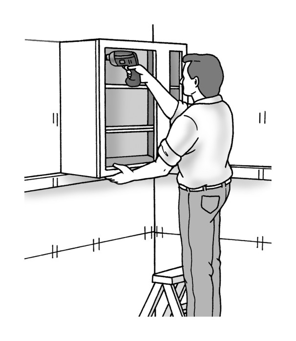 Figure 2-5: Position the wall cabinet on the ledger board and drive 3-inch-long cabinet screws through the top and bottom hanging rails and into wall studs.